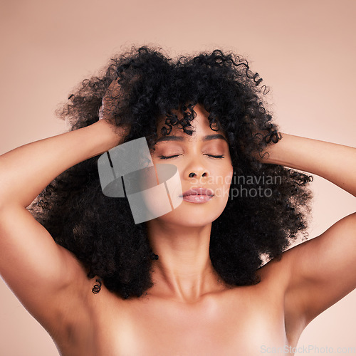 Image of Natural, hair and beauty by black woman in studio for grooming, makeup and cosmetics on brown background. Glow, skincare and afro haircare by girl model relax with luxury, pamper and routine isolated