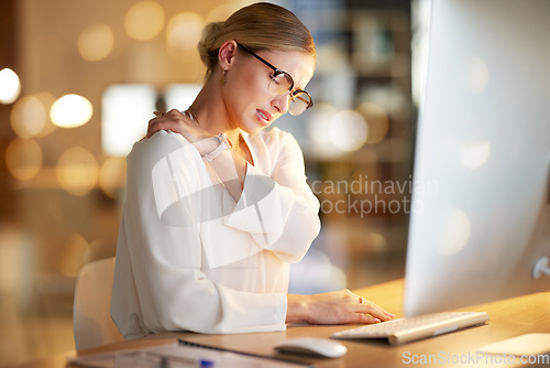 Image of Night, employee and woman shoulder pain, stress and overtime for business deal, startup and deadline. Leader, female manager and entrepreneur with injury, tired and bruise in office and working late
