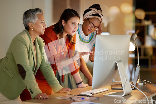 Image of Training, planning and women on a computer for strategy on a project deadline at night. Meeting, advice and business employees reading information on a corporate plan during overtime in a dark office