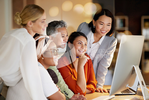 Image of Happy, women and creative collaboration on computer at night in office for teamwork, planning or design. Lady, partnership or designer team coworking on online project, vision or proposal strategy