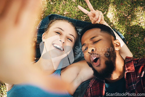 Image of Peace sign selfie, couple and portrait smile at park outdoors, laughing at comic joke and bonding. Diversity, love romance and black man and woman with v hand emoji to take photo for happy memory.