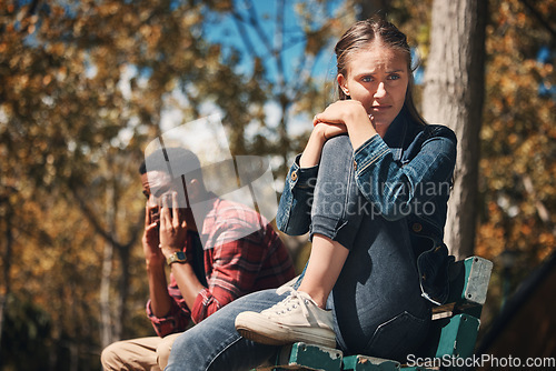 Image of Hiking, conflict and couple argue in a forest, annoyed and sad while sitting, lost and unhappy. Sad, woman and man arguing while hiking in nature, upset and angry, disappointment and breakup, trouble