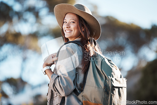 Image of Hiking, portrait and woman in nature for freedom, travel and backpacking adventure on blurred background. Face, girl and traveler walking in a forest, smile and excited for journey, vacation or trip