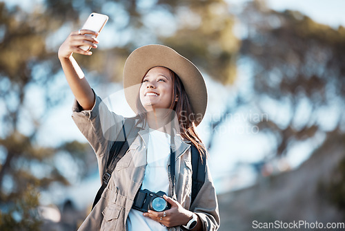 Image of Woman, tourist and smile for travel selfie on hiking adventure, backpacking journey or profile picture in nature. Female hiker smiling for photography, memory photo or scenery in mountain trekking