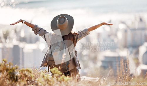 Image of Woman, tourist and hiking or travel freedom in city for adventure, backpacking or journey on mountain in nature. Female hiker with open arms enjoying fresh air, trekking or scenery of an urban town