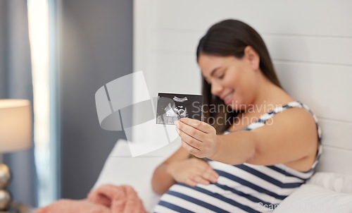 Image of Pregnant, woman and ultrasound in hand for baby development or growth. Happy person show baby scan photograph for gynecology, pregnancy update and health or wellness with sonogram in home bedroom