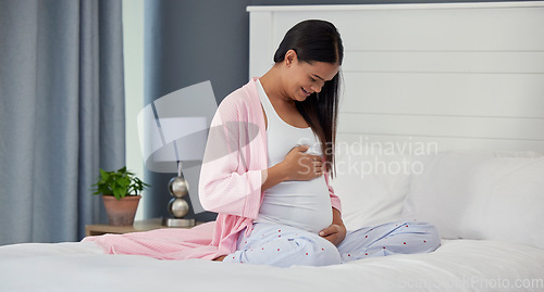 Image of Pregnant woman, stomach and love in home bedroom happy about bonding and movement. Mother to be person with hands on abdomen for healthy pregnancy development, body wellness and care on her bed