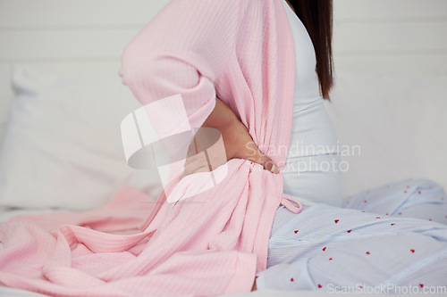 Image of Tired, healthcare and pregnant woman with back pain on a bed for rest, break and maternity leave. Sick, injury and girl with backache, fatigue and stress during pregnancy in a bedroom for motherhood