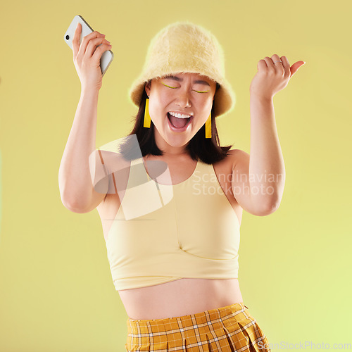 Image of Phone, wow and celebration of woman in studio isolated on a yellow background. Excited winner, surprise and happy female with mobile smartphone celebrating after winning success, good news or lottery