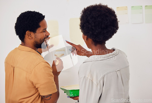 Image of Painting, wall or happy black couple in DIY, home renovation or house remodel together with a paintbrush. Back view, smile or African man speaking to a woman working with team work in partnership