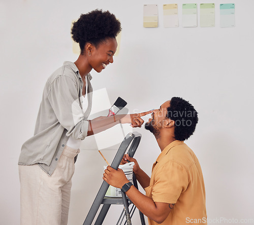 Image of Painting, ladder or funny black couple in DIY, home renovation or house remodel together with paintbrush. Playing, smile or African man laughing with happy woman working with teamwork in partnership