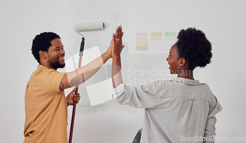 Image of Painting, success or black couple high five in DIY, home renovation or house remodel together with a paintbrush. Happy smile, woman and fun African man with teamwork or support for decoration designs