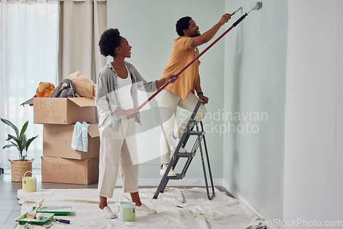 Image of Painting, teamwork or black couple home renovation, diy or house remodel together with paintbrush or roller. Happy smile, woman and African man love working on wall with partnership or collaboration