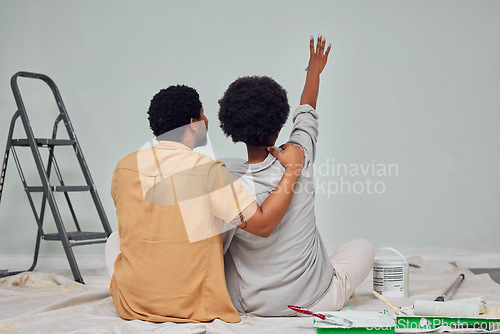 Image of Painting, wall or black couple planning DIY, home renovation or house remodel together on floor. Back view, pointing or African man loves speaking to young woman working with teamwork in partnership