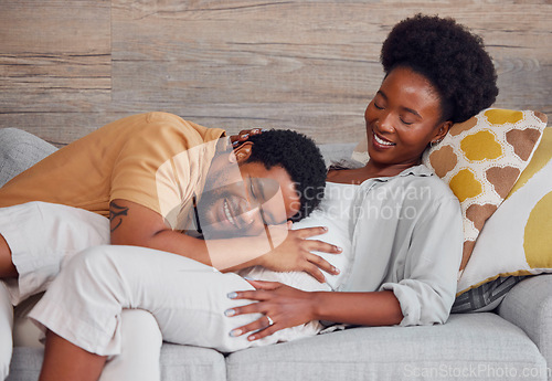 Image of Pregnant, black couple and listening to stomach while excited and happy on lounge couch. Man and woman together talking pregnancy future, love and life insurance for healthy lifestyle and heartbeat