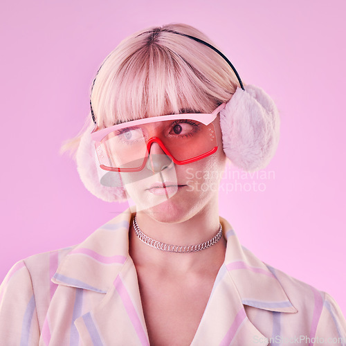 Image of Woman, fashion and unique on a pink background in studio with funny glasses for cyberpunk style. Face of edgy, trendy or retro aesthetic person thinking vaporwave, creativity and art color clothes