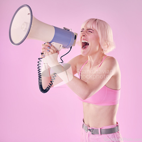 Image of Woman, megaphone and gen z protest on pink background of speech, announcement and noise sound. Feminist broadcast voice for human rights, justice and fight of gender equality, opinion or revolution