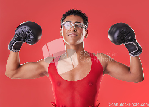 Image of Portrait, boxing and strong gay man with motivation isolated on a red background in a studio. Fight, fitness and lgbt person showing muscle from self defense exercise, training and challenge