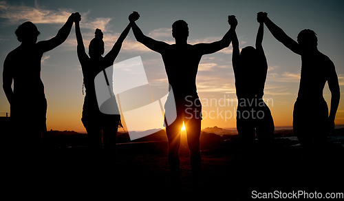 Image of Friends, celebration and holding hands on sunset beach silhouette, nature freedom or community trust support. Men, women and people sunrise shadow in solidarity, team building or travel bonding goals