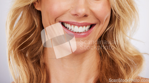 Image of Closeup, smile and woman mouth in studio for dental, hygiene or teeth whitening on grey background. Oral, zoom and cleaning for lady satisfied with bleaching, braces or porcelain veneers results