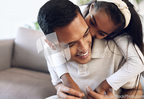 Image of Family, hug and girl with father on sofa, happy and laugh, kiss and bonding in their home. Embrace, smile and parent with child on couch, play or enjoy day off, weekend or piggyback in a living room