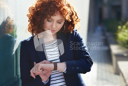 Image of Woman in city, checking time and smartwatch on wrist on morning commute to work or appointment. Street, schedule and businesswoman looking at watch on urban sidewalk before job interview or meeting.