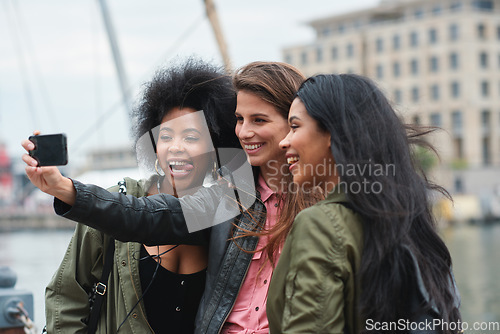 Image of Selfie, travel or bonding with tourist friends taking a picture outdoor together in a foreign city abroad. Happy, smile or diversity with a group of women overseas on vacation posting on social media