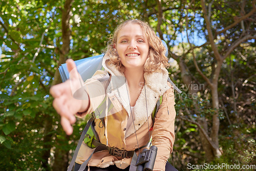 Image of Woman hiking, nature portrait and helping hand pov with happiness, goal or outdoor adventure in summer. Happy hiker girl, free and smile in sunshine, woods or forest on walk with backpack on holiday