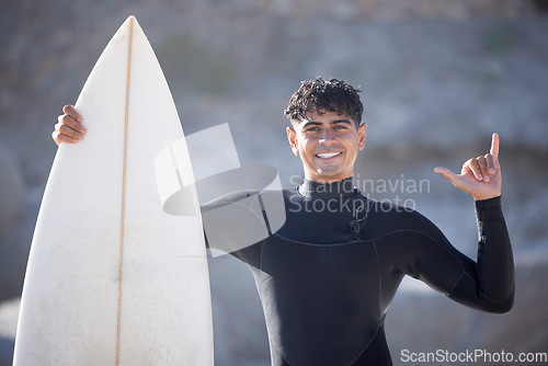 Image of Surfer man, hand sign and portrait at beach, summer sports and freedom in sunshine. Surfing board, shaka and guy relax at ocean on adventure, sea travel and smile on holiday, vacation or fun in Miami