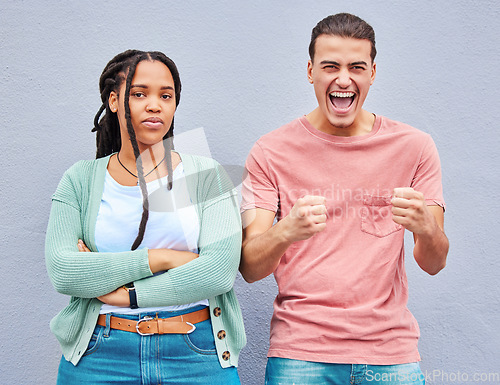 Image of Bored, excited and portrait of an interracial couple with arms crossed, anger and happy about a win. Sad, smile and young man and woman looking angry, comic and mad about losing in a competition