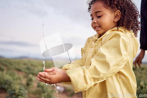 Image of Kid, child and young girl washing hands for hygiene and sustainability in nature on a farm in winter. Water and splash outdoor by rinsing and cleaning hand for eco friendly or natural sanitation