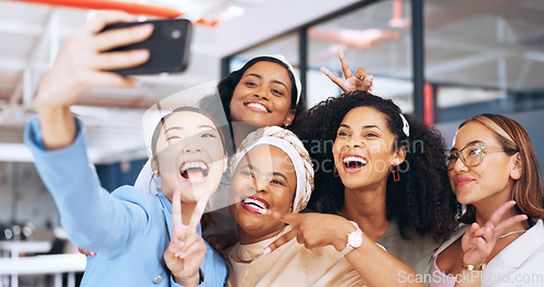 Image of Business people, peace sign and phone selfie in office for happy memory, profile picture or social media. Tech, cellphone and group of women, friends or coworkers taking pictures on mobile smartphone