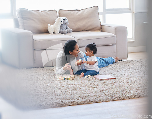 Image of Baby, mom and living room fun of a mother and kid with toys for knowledge development. Smile, happiness and parent care on a lounge rug in a home with mama love and bonding together with a child