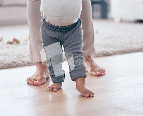 Image of Baby feet, walking and learning with mother in a living room lounge with mobility development. Floor, home and first steps of a young kid with mama together with love, care and support in a house