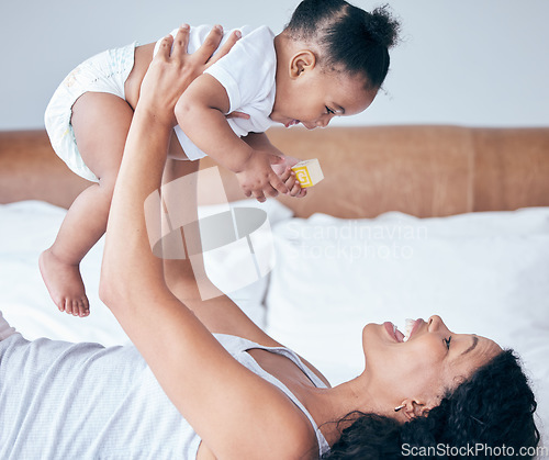 Image of Happy mom, bedroom and baby in the air with parent care and love at home in morning, Child, mother and happiness of a young mama with a kid playing and having fun together in a house with childcare