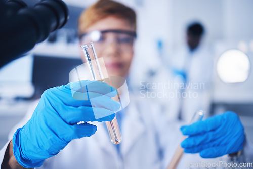 Image of Glass vials, science and female scientist doing research, experiment or tests in a medical lab. Innovation, professional and senior woman scientific researcher working in a pharmaceutical laboratory.