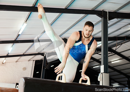 Image of Sports, gymnastics and man training on a beam for balance, flexibility and strength in the gym. Fitness, athlete and male gymnast practicing a routine for a competition or performance in an arena.