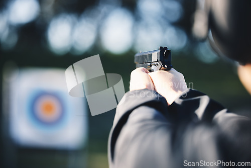 Image of Gun, target and person training outdoor for shooting range, game exercise or sports event closeup. Hands with firearm and circle for aim, vision and practice, police learning academy or field gaming