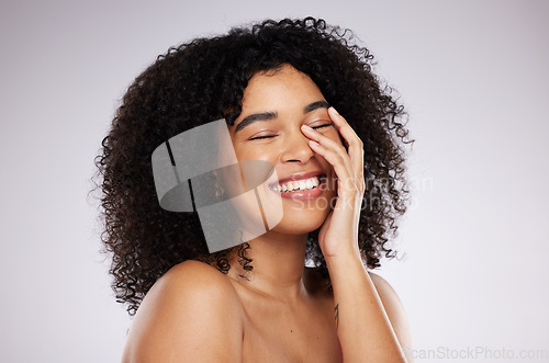 Image of Skincare, beauty and woman in a studio with a natural, cosmetic and facial health treatment. Wellness, cosmetics and happy female model from Mexico with a self care face routine by a gray background.