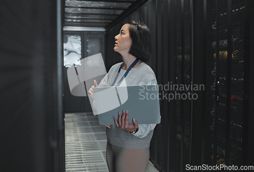 Image of Woman with laptop, server room and information technology, engineer and datacenter with software update. Tech industry, cybersecurity and network with Asian female setting up firewall and database