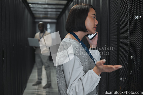 Image of Phone call, technician and woman in a server room for maintenance, repairs or data analysis. Systems, technology and Asian female engineer on mobile conversation while checking power of cable service