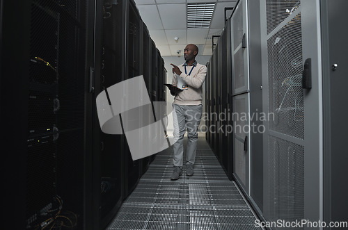 Image of Technician, cybersecurity and man in the server room for data maintenance, it or analysis. System, engineer and African male coder or programmer doing inspection on information technology in office.