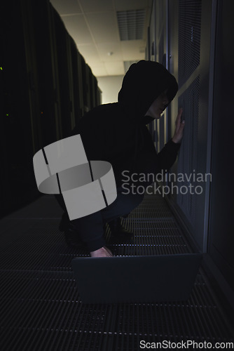 Image of Hacking, server room and person on laptop for coding software, data center crime and cyberpunk in dark. Network hacker, woman or user in cybersecurity, information technology or programmer ransomware