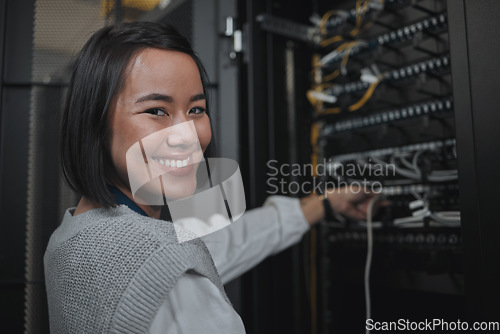 Image of Asian woman, portrait smile and technician by server for networking, maintenance or systems at office. Happy female engineer smiling for cable service, power or administration in data center room