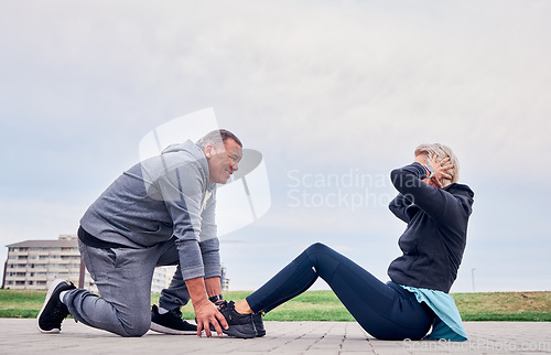Image of Fitness, health and sit ups with a senior couple training outdoor together for an active lifestyle of training. Workout, exercise or core with a mature man and woman outside on the promenade