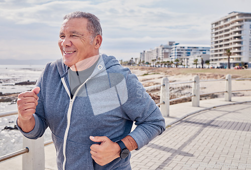 Image of Senior man, fitness and running at ocean sidewalk for energy, wellness or workout in Miami. Elderly male, cardio exercise and happy runner at seaside promenade of training, sports and smile of action