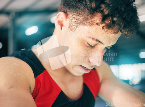 Image of Fitness, sweat and man in gym, tired and exercise with wellness, healthy lifestyle and training. Sports break, male and athlete sweating, drops and exhausted after practice, workout and breathing