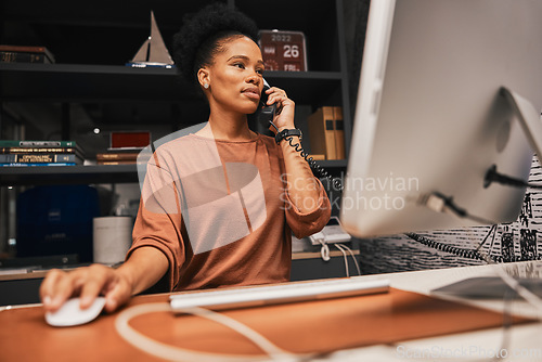 Image of Telephone, office and business woman on computer working on corporate project while on call. Professional, career and African female employee doing research on desktop for company report in workplace