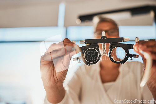 Image of Vision, hands and test frame for optometry in hospital or clinic for ophthalmology. Doctor, healthcare and female, woman or medical optician with glasses or lens for eyes examination or eye care.