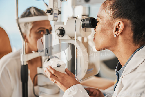 Image of Optometry, ophthalmology and eye exam by optometrist with a patient senior woman with medical insurance using slit lamp. Doctor, eyesight and healthcare professional doing vision test in clinic